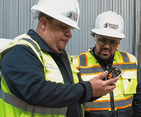 two men pointing at a truck